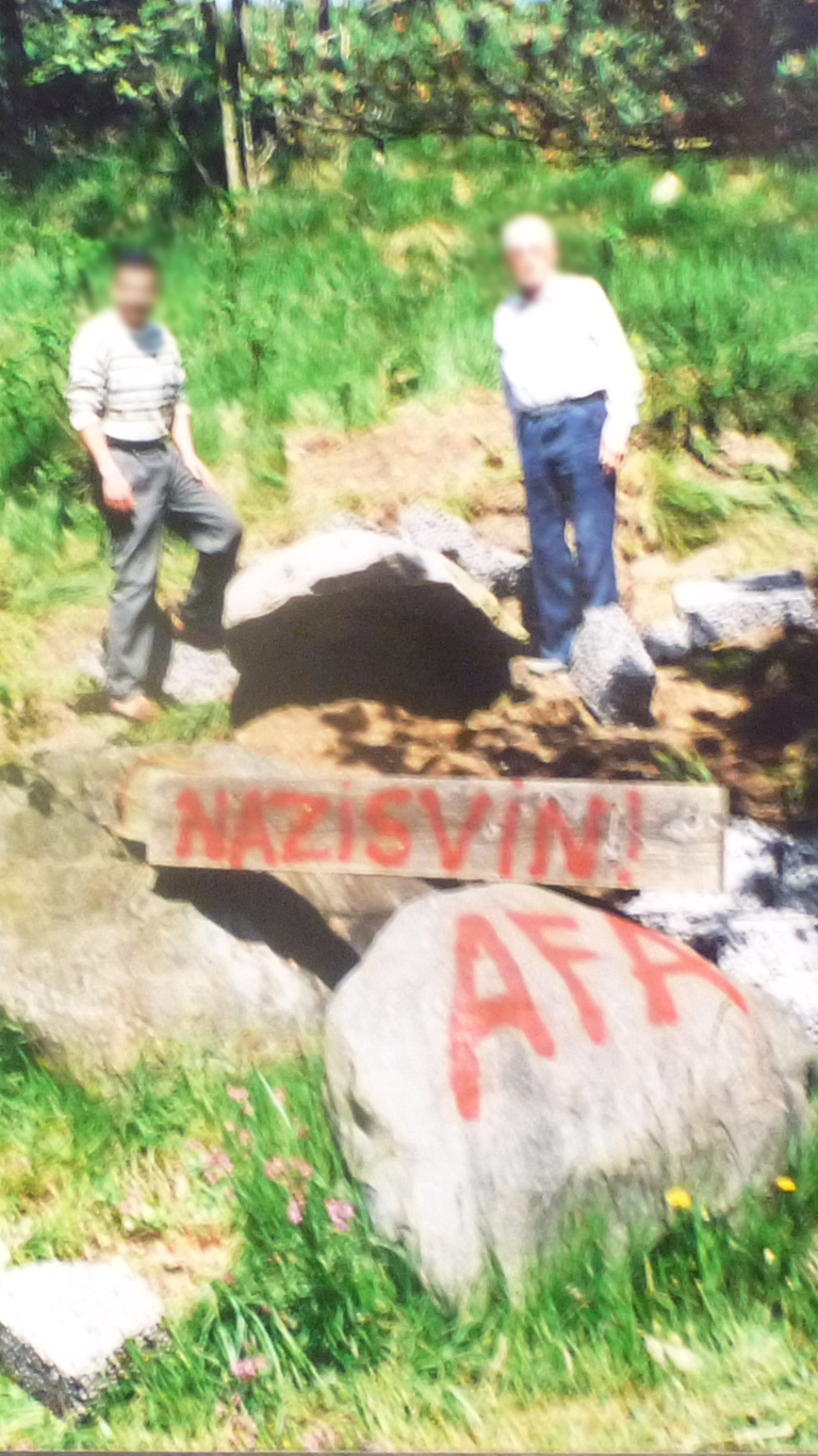 Sympathizers of the memorial grove inspect the damages after the vandalism in 2002. Their faces have been blurred. Source: Private archive.